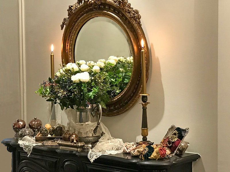 white roses, pomegranates, decorated eggs, birds, candles, mirror