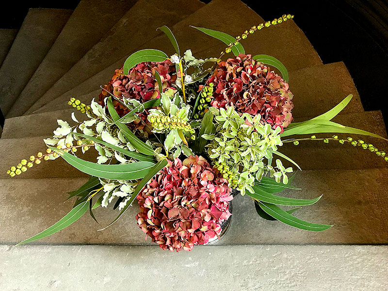 Hydrangeas bouquet of weathered red tones with foliage
