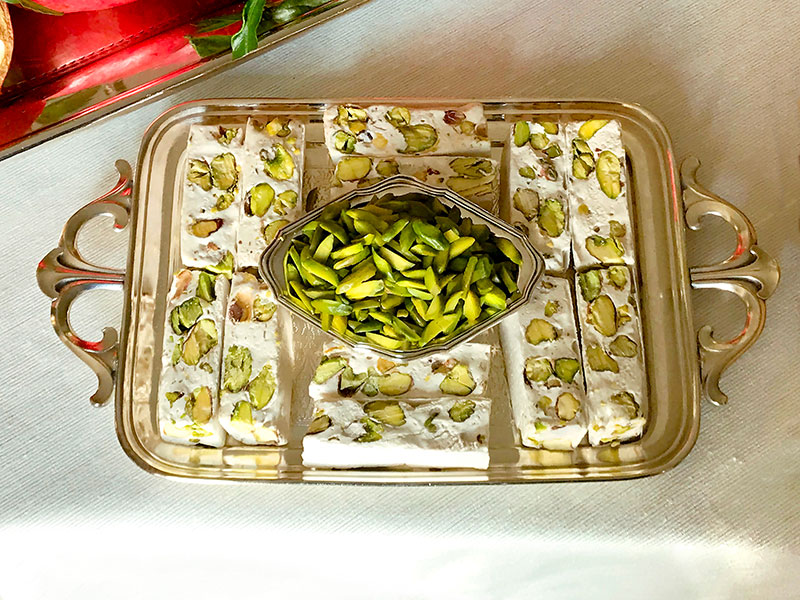 container of Persian nougat with pistachios