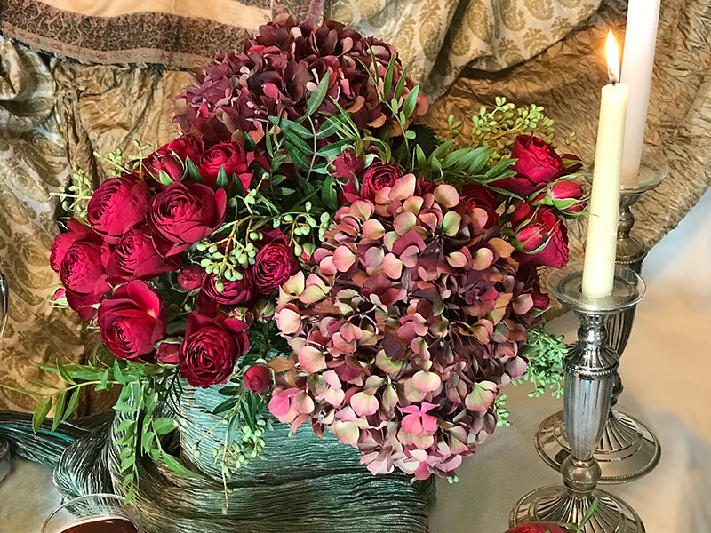 deep-red hydrangeas and candle