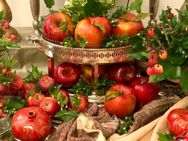 Sofreh with two-tiered, antique silver-plated container with a variety of apples