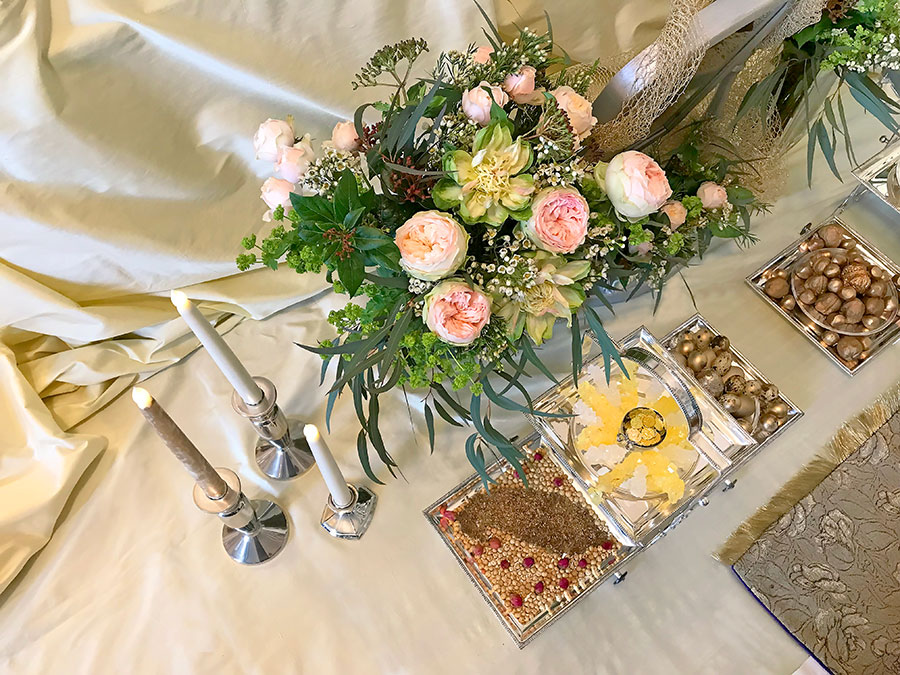 top view of roses, seeds and pods, candles