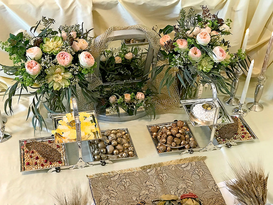 sofreh with candles, bouquets, and symbolic displays