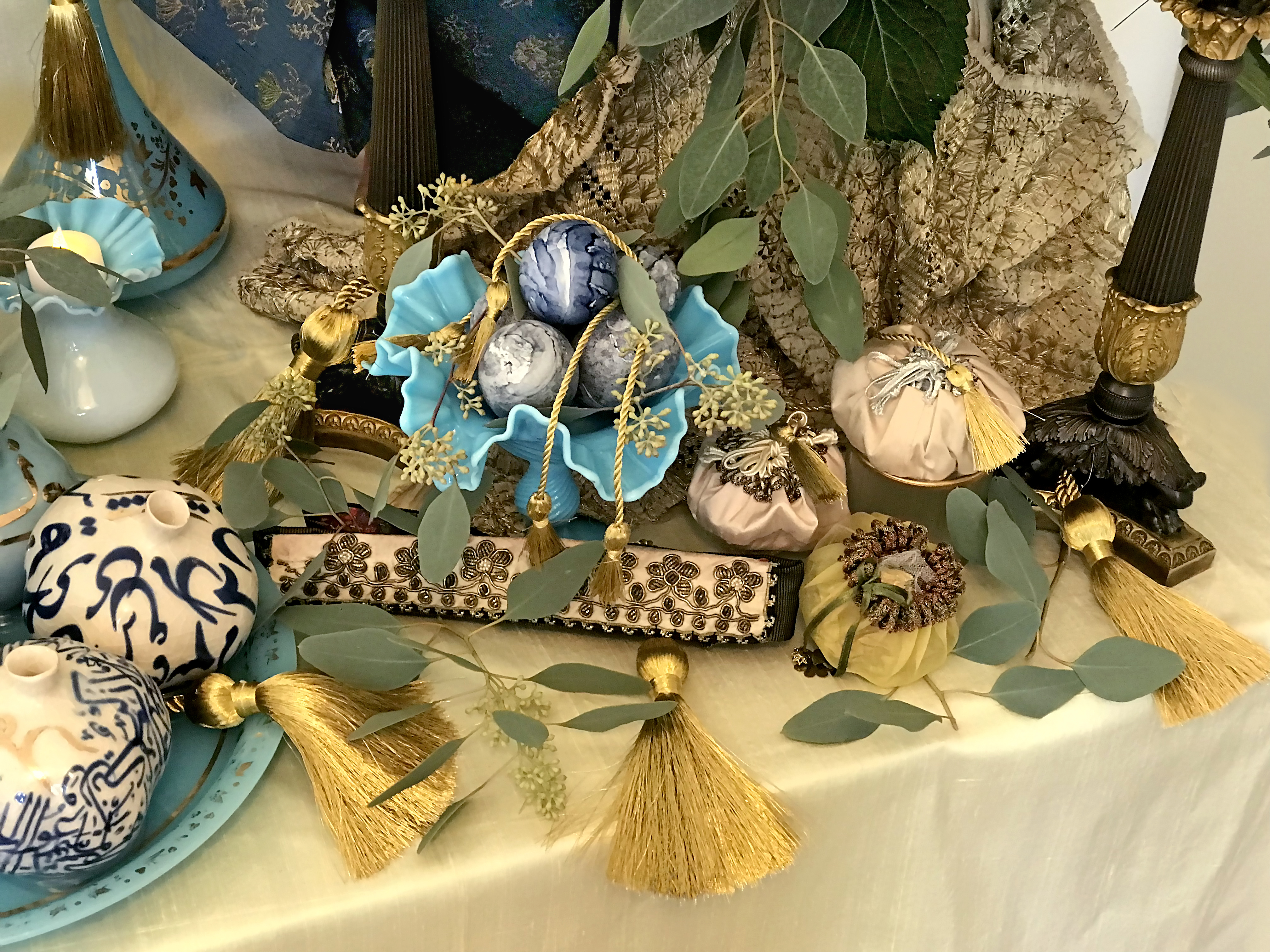 Blue painted eggs, bonbonnieres on Indian ivory and gold textile