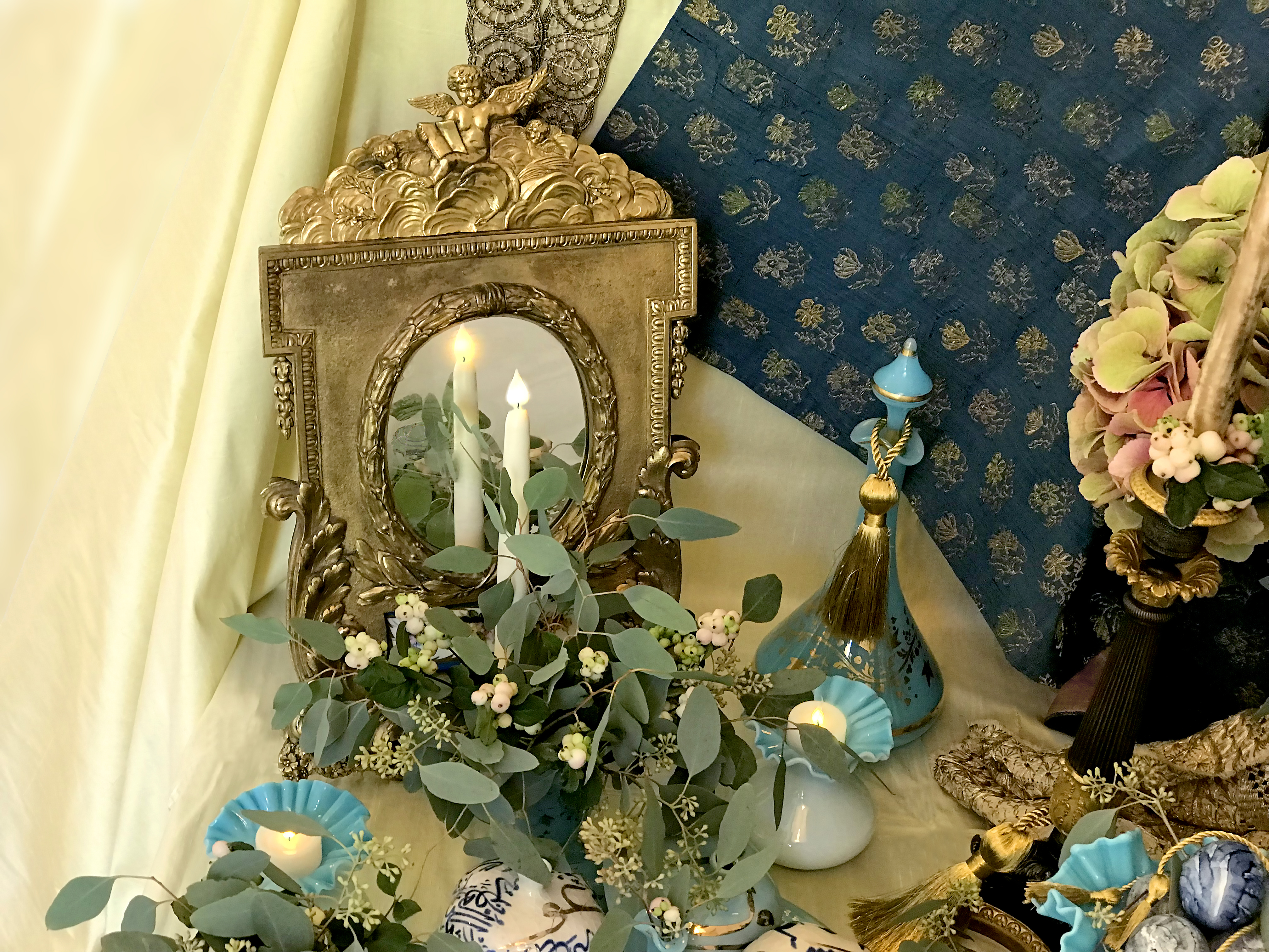 Mirror, candles, bouquet of Boteroesque hydrangeas