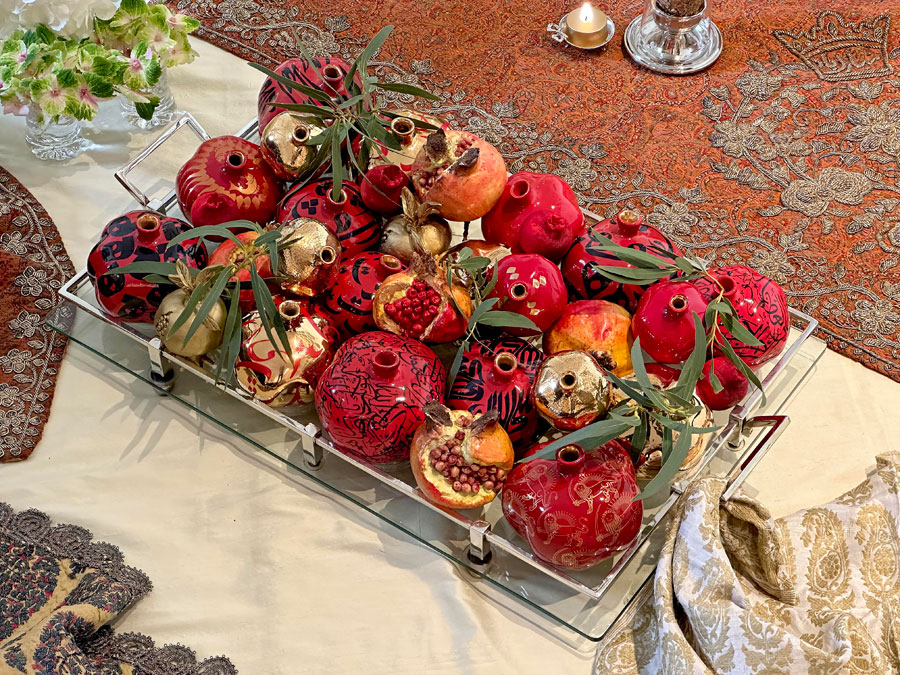 sculptured pomegranates presented on a large crystal and silver-plated tray