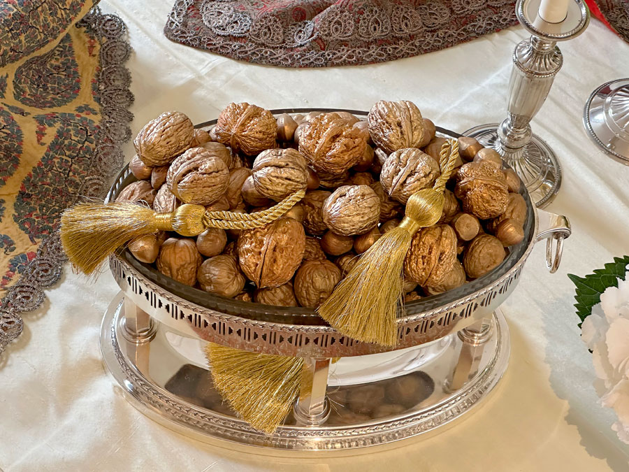 mixture of gold-tinted nuts in an attractive tiered antique crystal and silver-plated container