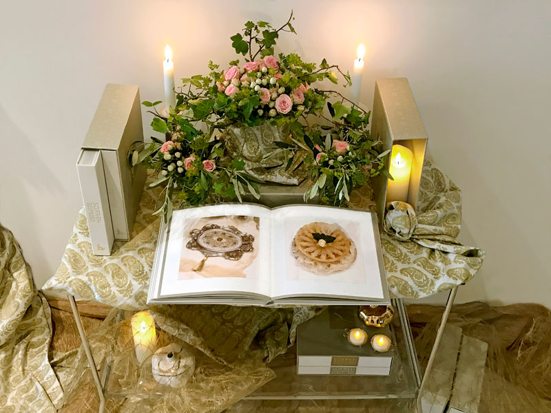 ggg30April25MayIMG_9655 several volumes of the book with delicate bouquets of spray roses and foliage and lengths of fine textiles