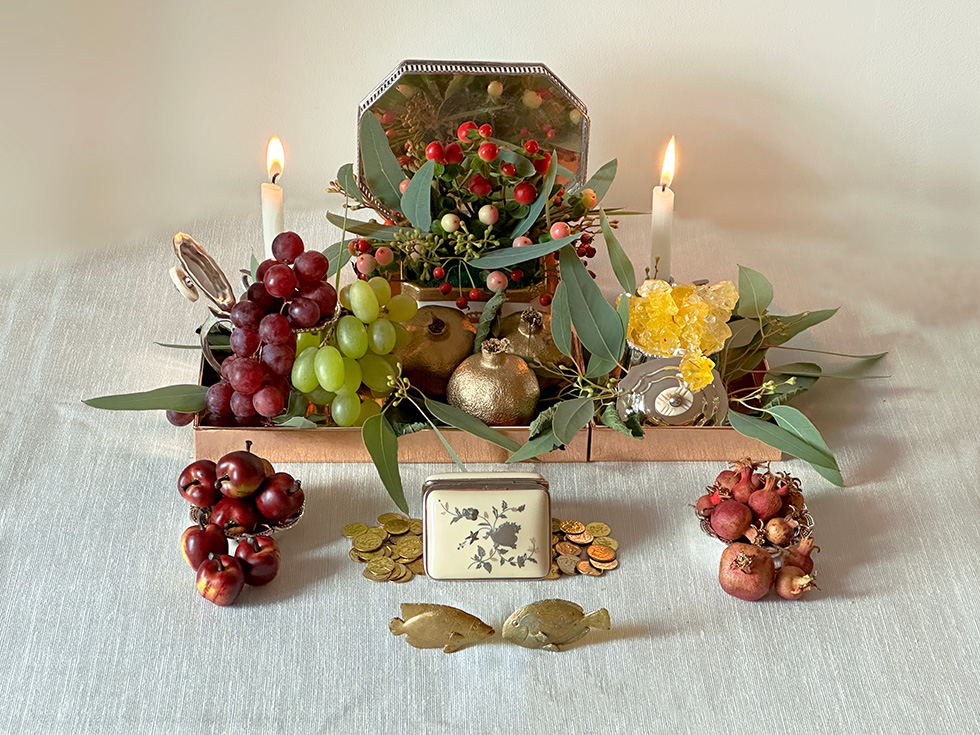 mini sofreh with candles and fruit